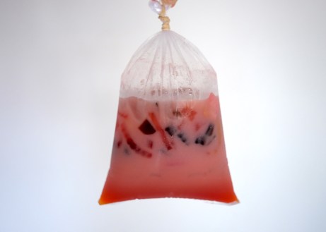 plastic bag full of sweetened milk drink with floating colourful jelly
